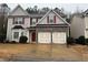 Charming two-story home with stone accents, red shutters, and a two-car garage at 114 Crescent Woode Way, Dallas, GA 30157