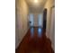 Hallway with wood flooring, multiple doors, and front door entrance at 114 Crescent Woode Way, Dallas, GA 30157