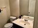 A powder room features a vanity and toilet at 114 Crescent Woode Way, Dallas, GA 30157