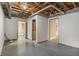 Unfinished basement with exposed ceiling and access to various rooms at 624 Longbow Ct, Stone Mountain, GA 30087