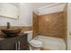This bathroom has tile-surrounded tub and sink, along with wood vanity at 624 Longbow Ct, Stone Mountain, GA 30087