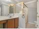 Bathroom with tiled floors, a single vanity, framed mirror, and glass-enclosed shower stall at 624 Longbow Ct, Stone Mountain, GA 30087