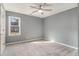 This bedroom features soft gray walls, plush carpeting, and a lighted ceiling fan at 624 Longbow Ct, Stone Mountain, GA 30087