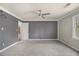 Bright bedroom with gray walls, plush carpet, a ceiling fan, and access to an ensuite bathroom at 624 Longbow Ct, Stone Mountain, GA 30087