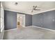 Spacious bedroom with plush carpet, ceiling fan and ensuite bathroom access through french doors at 624 Longbow Ct, Stone Mountain, GA 30087