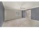 Main bedroom has a ceiling fan, plush carpet, and access to a large ensuite bathroom at 624 Longbow Ct, Stone Mountain, GA 30087
