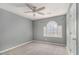 Bedroom featuring modern ceiling fan, gray walls, and a unique arched window that provides natural light at 624 Longbow Ct, Stone Mountain, GA 30087