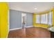 Bright dining room features hardwood floors, large bay window, and colorful accent walls at 624 Longbow Ct, Stone Mountain, GA 30087