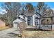 Charming home featuring a gazebo, stucco siding, blue trim, attached garage, and landscaped front yard at 624 Longbow Ct, Stone Mountain, GA 30087