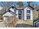 Charming two-story home featuring stucco siding, blue trim, attached garage, and landscaped front yard at 624 Longbow Ct, Stone Mountain, GA 30087