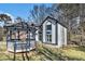 Charming home featuring a gazebo, manicured lawn, and unique architectural details under a clear blue sky at 624 Longbow Ct, Stone Mountain, GA 30087