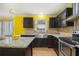Close up of kitchen featuring stainless steel appliances, granite countertops, and dark wood cabinets at 624 Longbow Ct, Stone Mountain, GA 30087