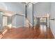 Large living room with hardwood floors, stairway to the second level, and an adjacent dining room at 624 Longbow Ct, Stone Mountain, GA 30087