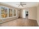 Spacious living room with wood-look floors, access to deck, and large windows offering outdoor views at 624 Longbow Ct, Stone Mountain, GA 30087