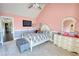 Charming pink bedroom with vaulted ceiling, a white bed set, and a dresser with mirror at 85 Tanglewood Dr, Covington, GA 30016