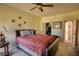 Cozy bedroom with a ceiling fan, closet and view into an arched hallway at 85 Tanglewood Dr, Covington, GA 30016