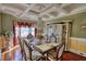 Elegant dining room featuring a chandelier, decorative ceiling, and formal dining set with seating for six at 85 Tanglewood Dr, Covington, GA 30016