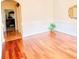 Bright entryway with hardwood floors, white wainscoting, and a decorative mirror, leading to an office at 85 Tanglewood Dr, Covington, GA 30016