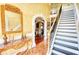 Grand foyer with ornate mirror, staircase and hardwood floors and archway at 85 Tanglewood Dr, Covington, GA 30016
