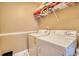 Convenient laundry room featuring a stacked washer and dryer set for efficient space-saving at 85 Tanglewood Dr, Covington, GA 30016