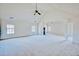 Large open living room with high ceilings and carpet, featuring bright windows and classic columns at 85 Tanglewood Dr, Covington, GA 30016