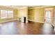 Open living room with hardwood floors, large windows, and neutral walls with stylish decorative moldings at 85 Tanglewood Dr, Covington, GA 30016