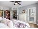 Main bedroom with modern furnishings, hardwood floors, and a chest of drawers leading to a balcony at 275 13Th St # Apt 509, Atlanta, GA 30309