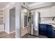 Modern kitchen with stainless steel refrigerator and appliances with entry way visible in the distance at 275 13Th St # Apt 509, Atlanta, GA 30309