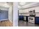Updated kitchen with stainless steel appliances, contrasting cabinets, and tiled flooring near the entry way at 275 13Th St # Apt 509, Atlanta, GA 30309