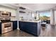 Bright kitchen with stainless steel appliances, tiled backsplash, and center island adjacent to living area at 275 13Th St # Apt 509, Atlanta, GA 30309