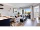 Living room with a balcony access featuring an ottoman, area rug, and comfortable seating with many throw pillows at 275 13Th St # Apt 509, Atlanta, GA 30309