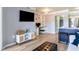 Open living room with hardwood floors, built in shelving, and modern furnishings next to the kitchen at 275 13Th St # Apt 509, Atlanta, GA 30309