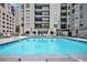Sparkling community pool surrounded by lounge chairs for residents at 275 13Th St # Apt 509, Atlanta, GA 30309