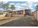 Backyard view of home with wooden deck and newly-constructed wooden fence at 3080 Hamilton Rd, Decatur, GA 30032