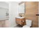 Modern bathroom with wood-look tiling, a vessel sink and a large mirror at 3080 Hamilton Rd, Decatur, GA 30032