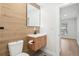 Contemporary bathroom featuring wood-look accent wall, modern vanity, and a doorway at 3080 Hamilton Rd, Decatur, GA 30032