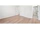 Spacious bedroom with wood-look floors, neutral walls, and two doors at 3080 Hamilton Rd, Decatur, GA 30032