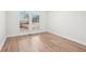 Bright bedroom with wood-look floors, neutral walls, and large windows with fenced backyard view at 3080 Hamilton Rd, Decatur, GA 30032