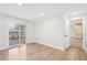 Bright bedroom with light wood floors, closet, and slider doors to a deck overlooking a lovely backyard at 3080 Hamilton Rd, Decatur, GA 30032