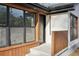 Close up of Entrance with wood siding, large windows, and a dark colored door at 3080 Hamilton Rd, Decatur, GA 30032