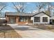 Charming bungalow-style home with painted white brick, attached garage, and a well-manicured front lawn at 3080 Hamilton Rd, Decatur, GA 30032