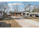 Charming bungalow-style home with painted white brick and attached garage at 3080 Hamilton Rd, Decatur, GA 30032
