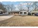 Charming bungalow-style home with painted white brick and attached garage at 3080 Hamilton Rd, Decatur, GA 30032