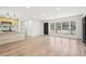 Spacious living area featuring new floors, recessed lights, a wet bar, and access to the outside patio at 3080 Hamilton Rd, Decatur, GA 30032