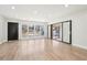 Spacious living area featuring new floors, recessed lights, a wet bar, and access to the outside patio at 3080 Hamilton Rd, Decatur, GA 30032