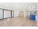 Spacious living area featuring new floors, recessed lights, a wet bar, and access to the outside patio at 3080 Hamilton Rd, Decatur, GA 30032