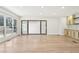 Spacious living area featuring new floors, recessed lights, a wet bar, and access to the outside patio at 3080 Hamilton Rd, Decatur, GA 30032