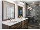 Bathroom with double sink vanity and glass enclosed shower with black tile at 1986 Memorial Se Dr, Atlanta, GA 30317
