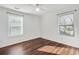 Cozy bedroom with hardwood floors, two windows, and white paint at 1986 Memorial Se Dr, Atlanta, GA 30317