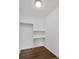 Walk in closet with white walls, hardwood floor and shelving at 1986 Memorial Se Dr, Atlanta, GA 30317